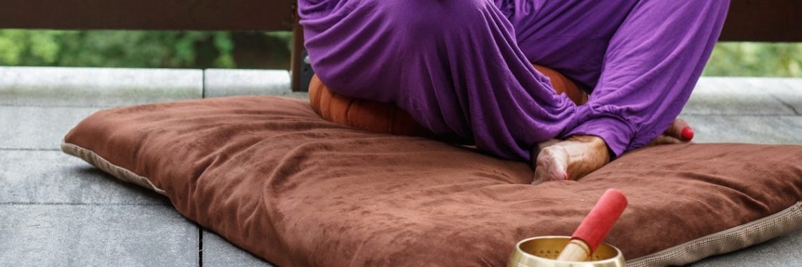 woman in purple dress sitting on gray couch